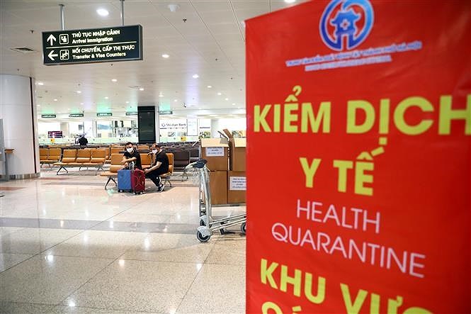 [Foto] Terminal internacional de Noi Bai refuerza control medico de pasajeros en su llegada al pais hinh anh 4